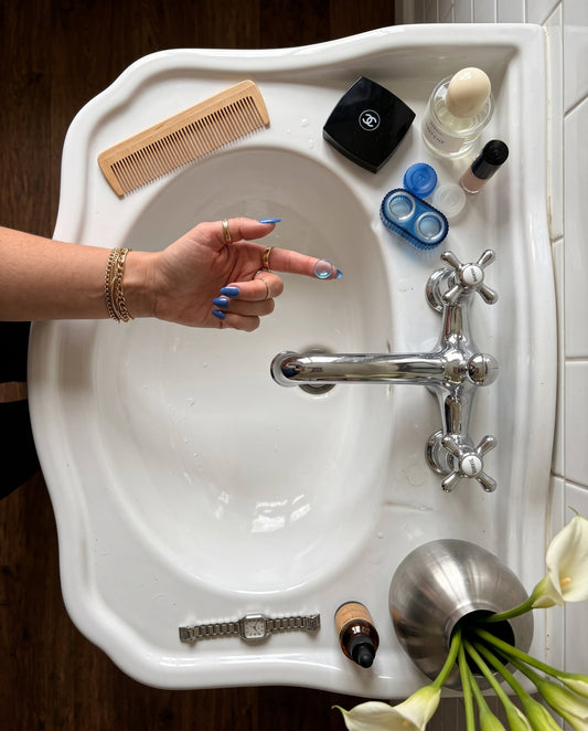 JADE contact lens case in a blue bathroom