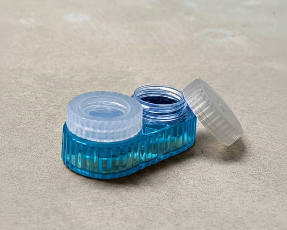 Blue contact lens case with a white cap on a beige surface