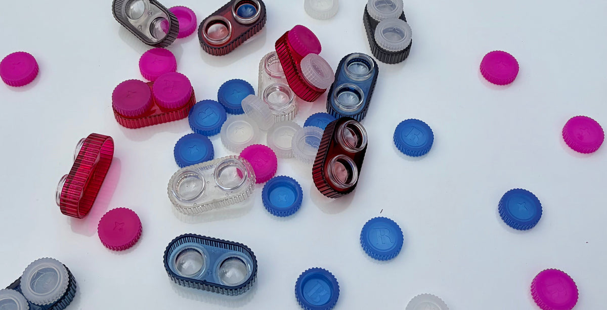 A pile of jade contact lens cases and their caps scattered around 